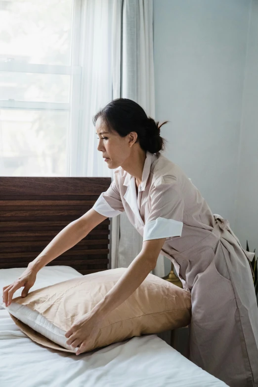 a lady laying down on the bed with pillows