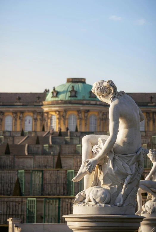 there are statues near each other outside of a building