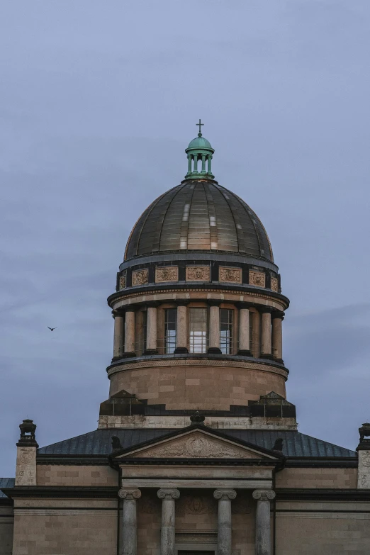 the dome of a building against a cloudy sky