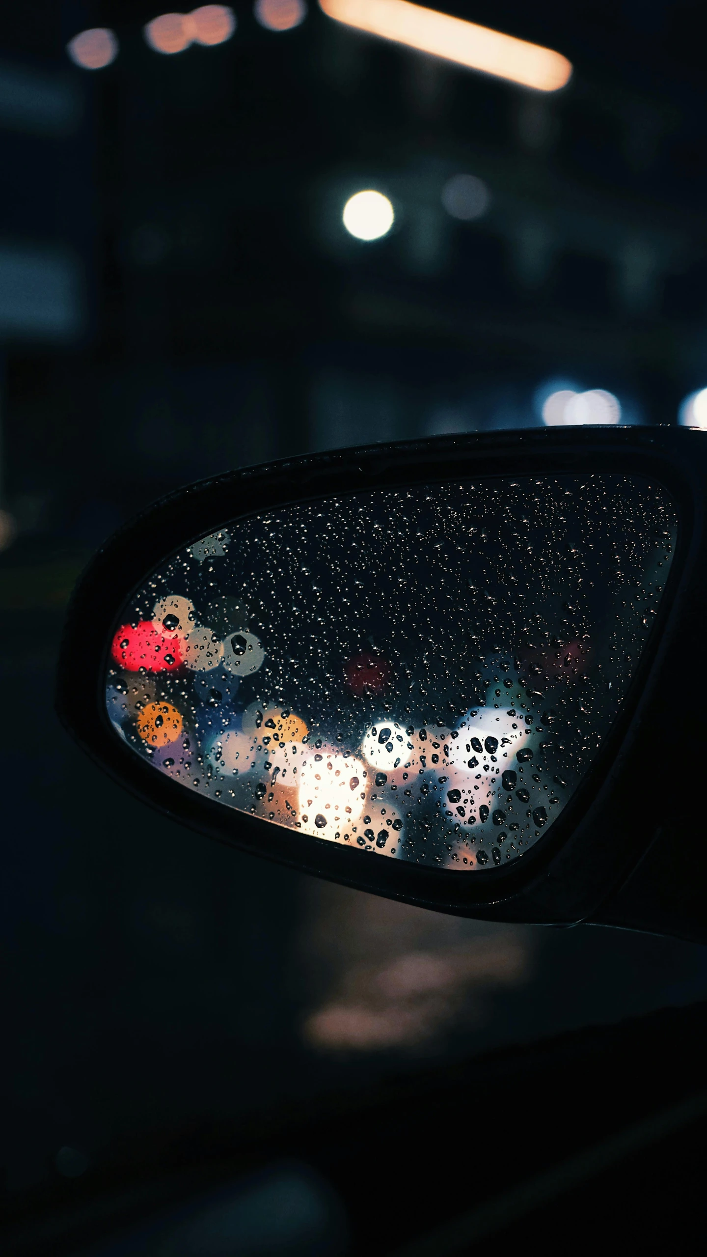 a close up of a car mirror with cars in the background