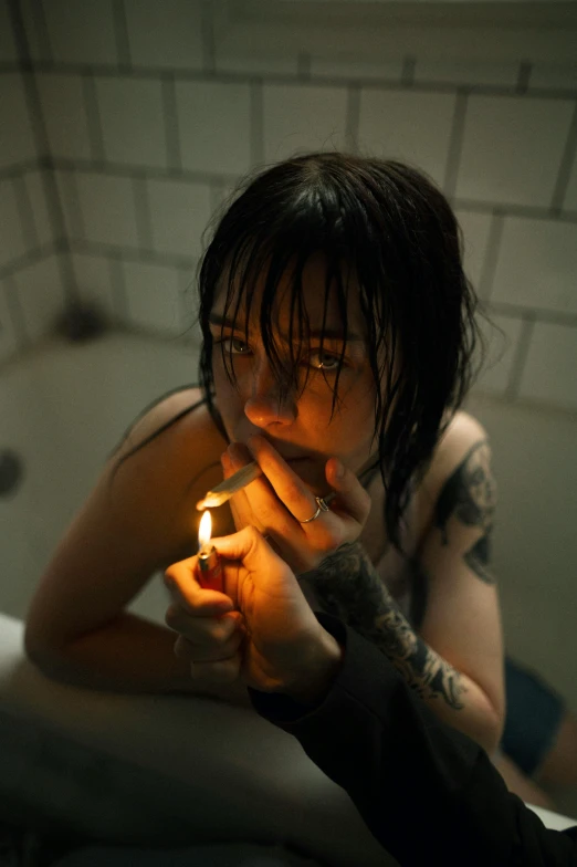 a person holding a lit cigarette in the corner