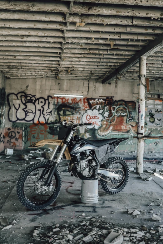 a dirt bike sits on top of an empty concrete lot