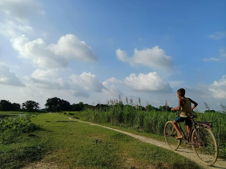 the man is riding his bike through the field