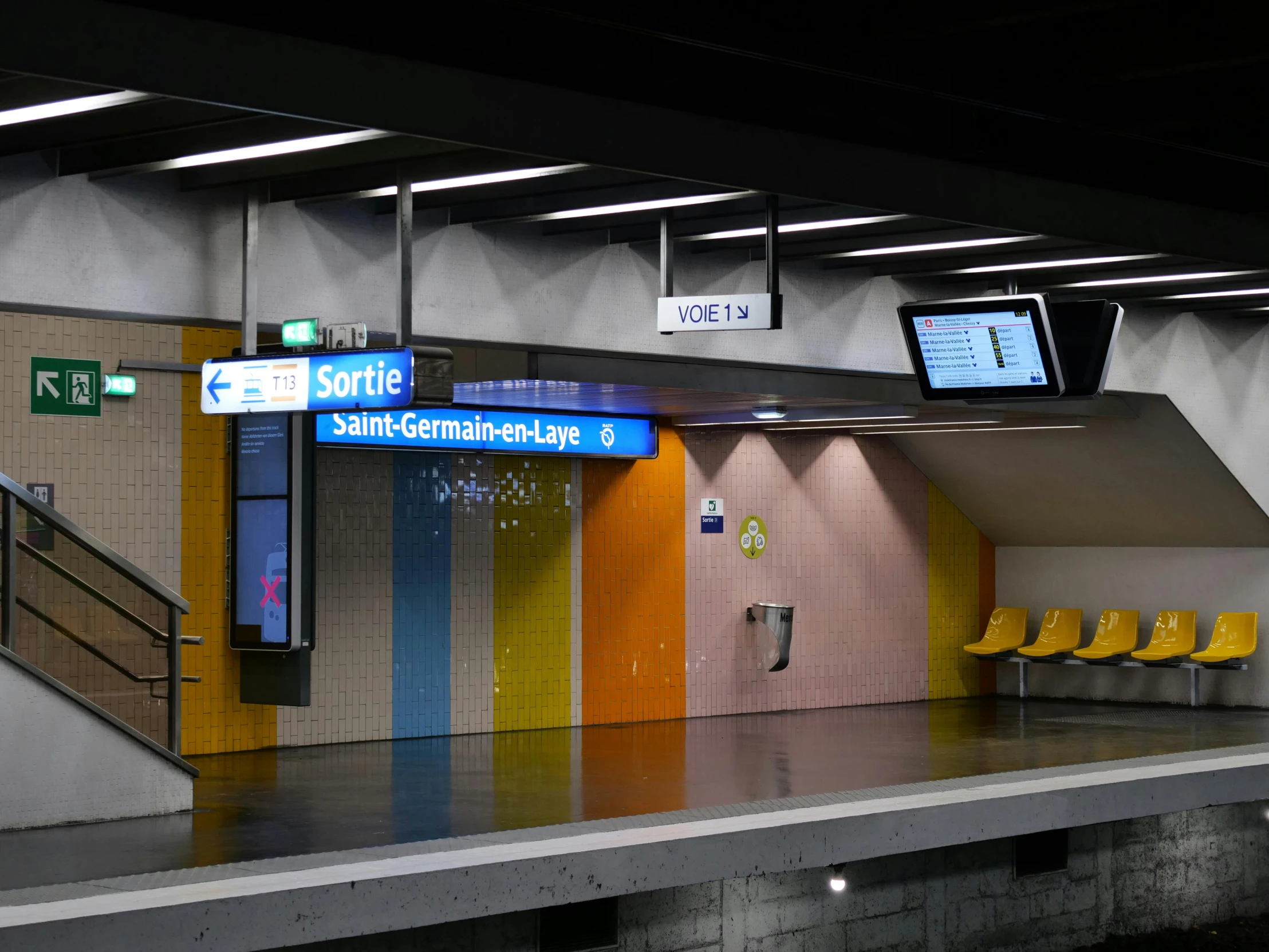 a large lobby with yellow chairs and signs