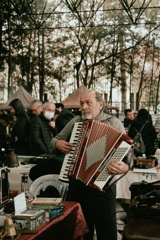 a man that is playing the accordion