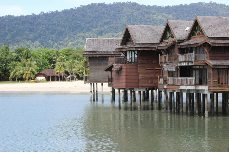 the wooden piers are next to the buildings on the water