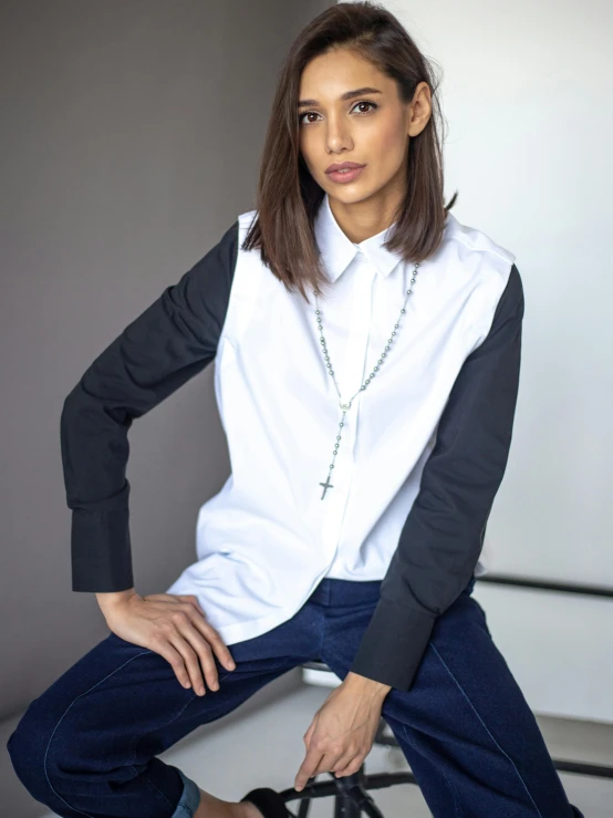 a women who is posing in a white shirt