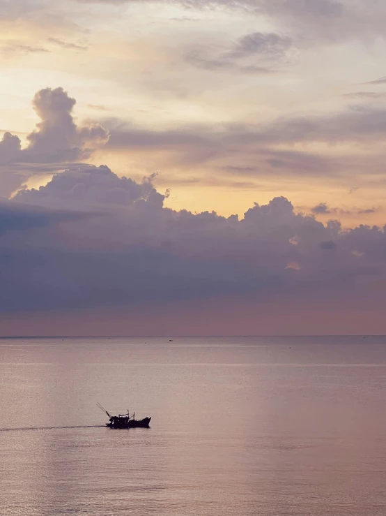 a lone boat in the middle of a calm body of water