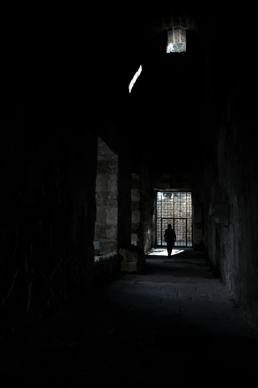 someone is standing in an old, creepy alley