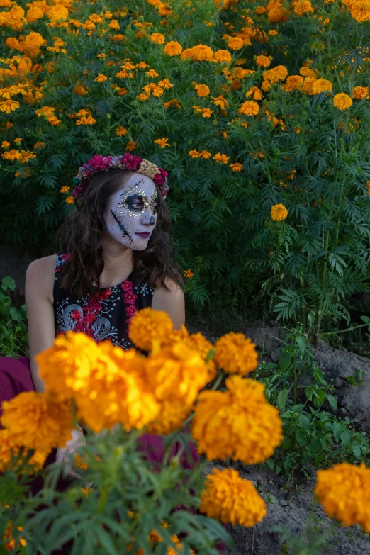 a woman with a mask on, in front of flowers