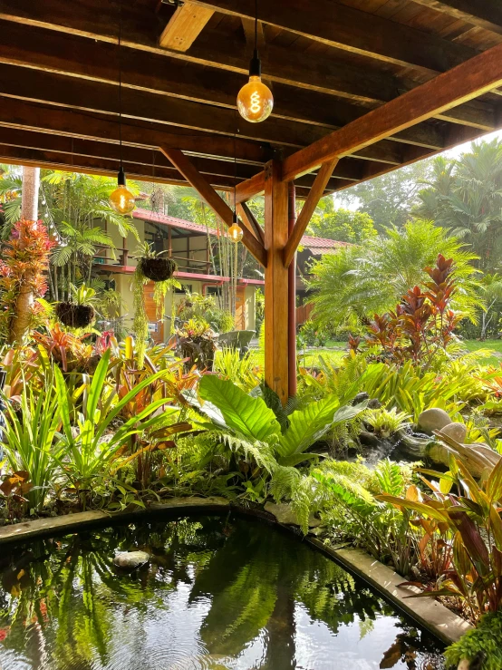 a covered patio with a pond in the middle