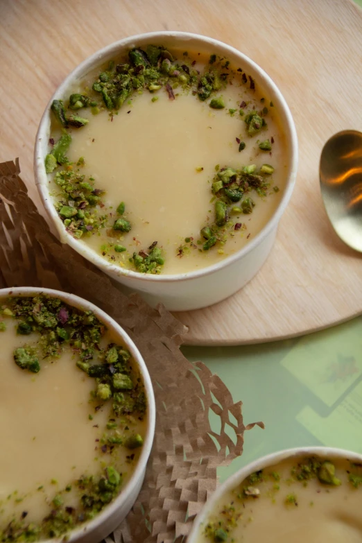 three bowls of soup with spoons next to them