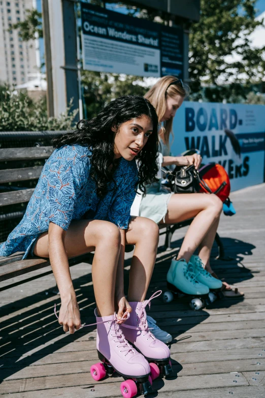 woman with skateboard sitting on bench in public