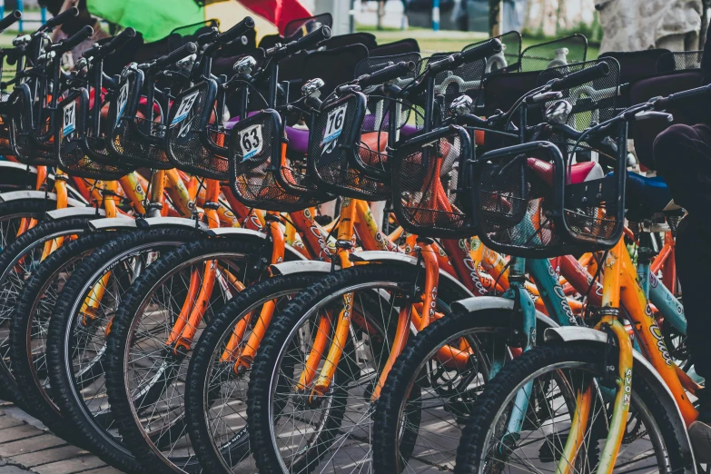 many colorful bicycles lined up in front of the building