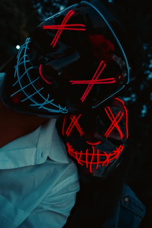 a man wearing a dark red mask with neon eyes