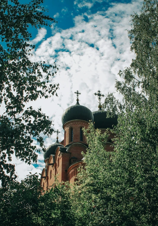 the building has two steeples and a cross on it