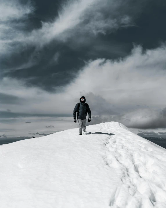 a person standing on top of a snow covered hill