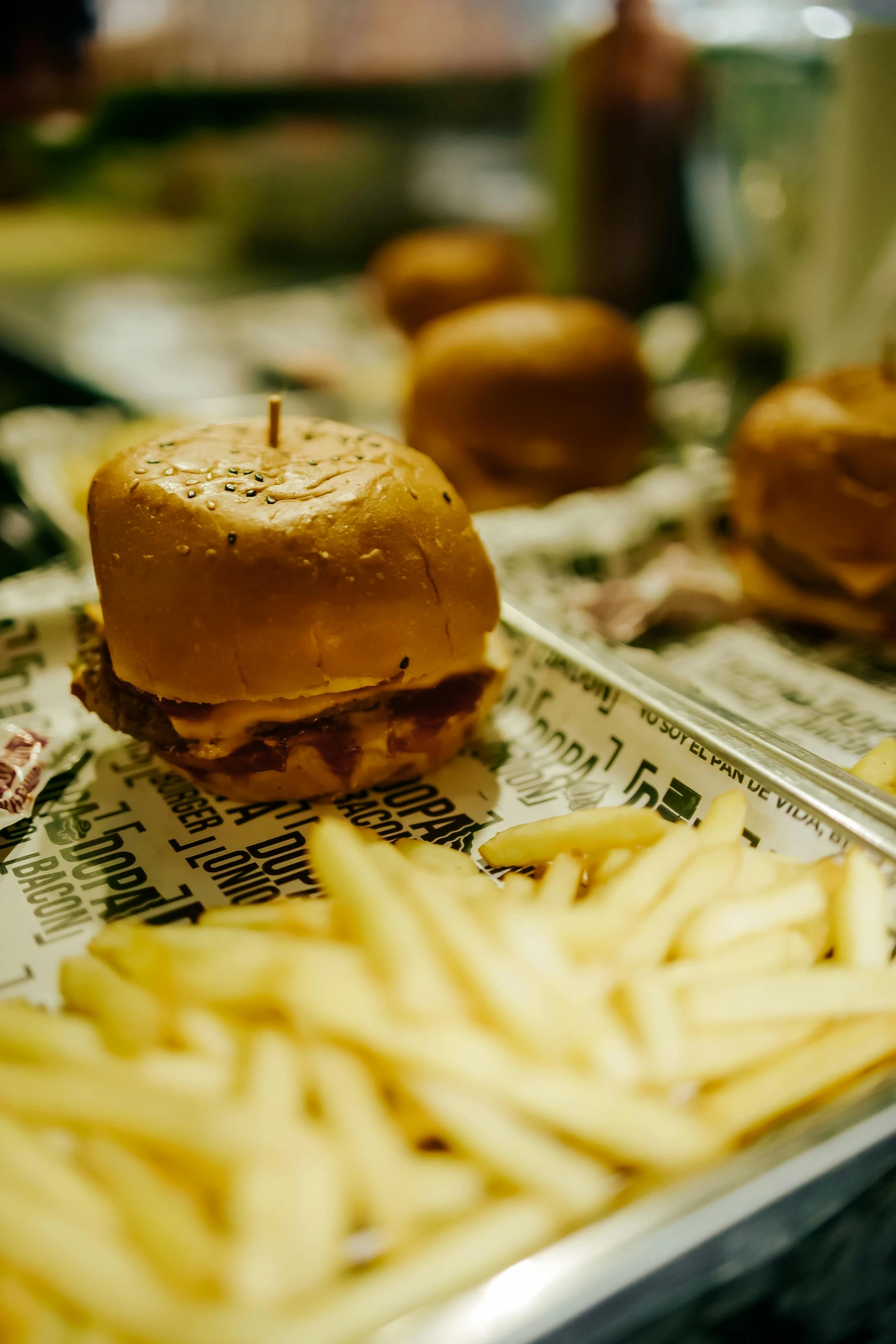 french fries and a hamburger are on a tray