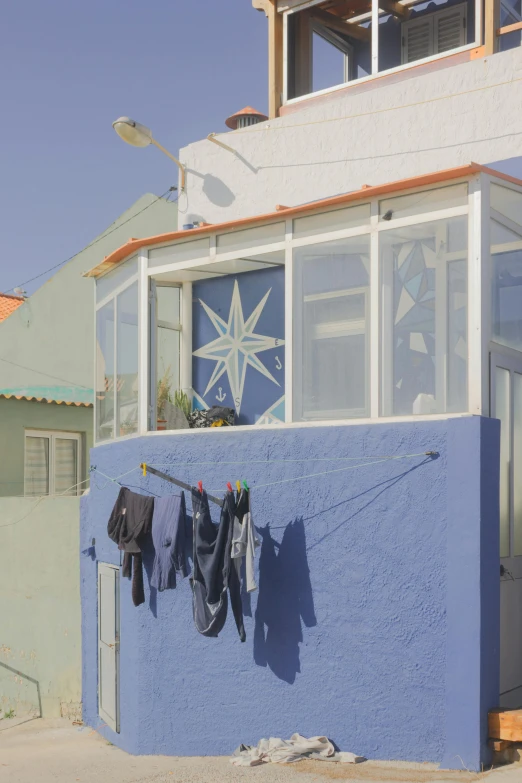 the clothes are hanging outside on a wire