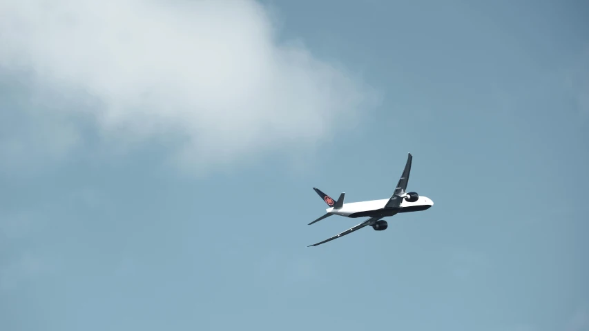 an airplane is seen from underneath in the blue sky