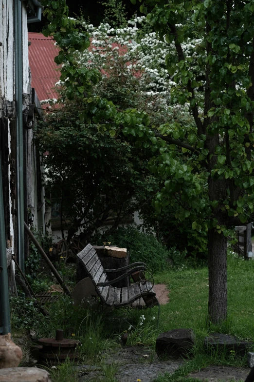 a very old wooden chair in a small yard