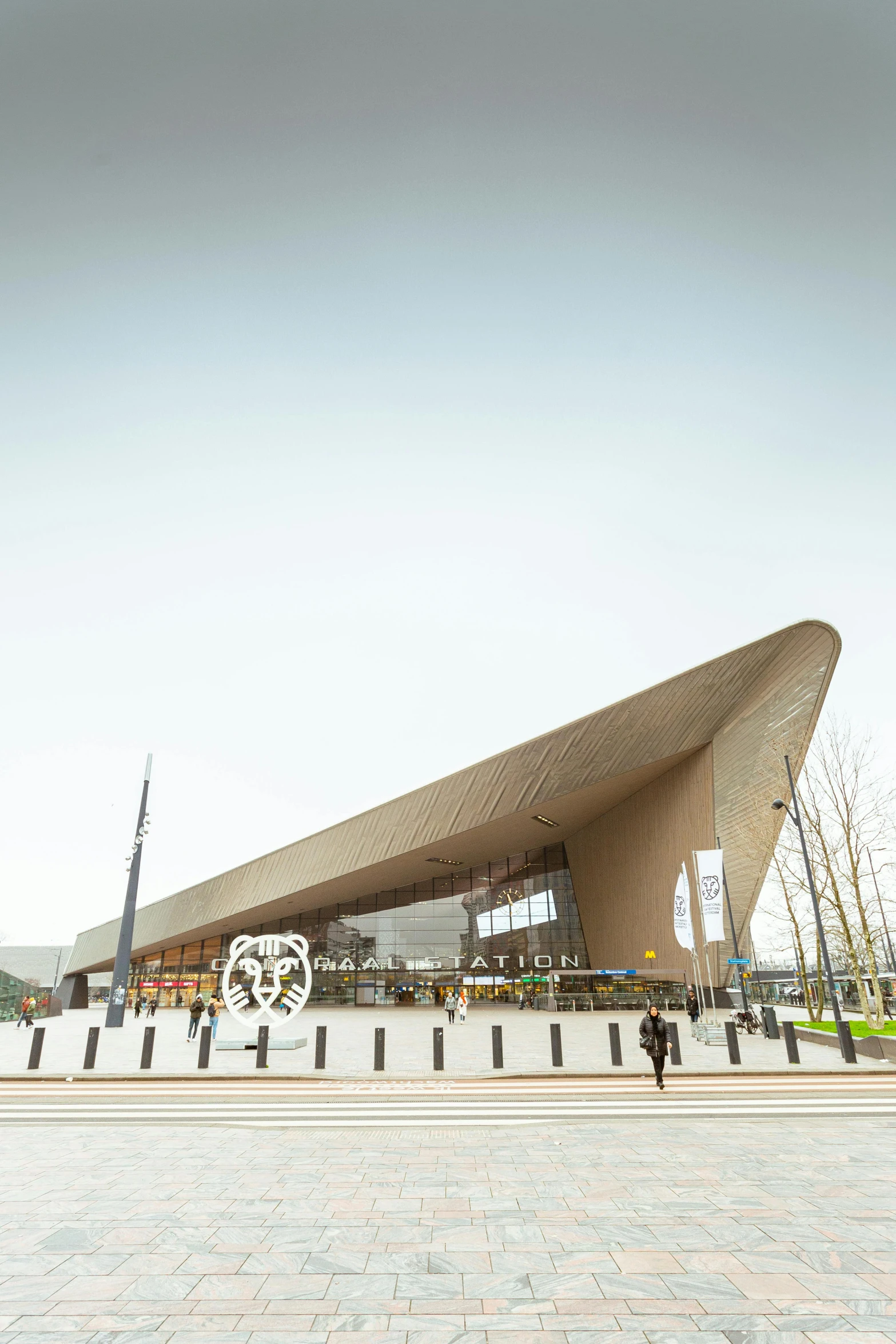 a large building with a very tall roof near people