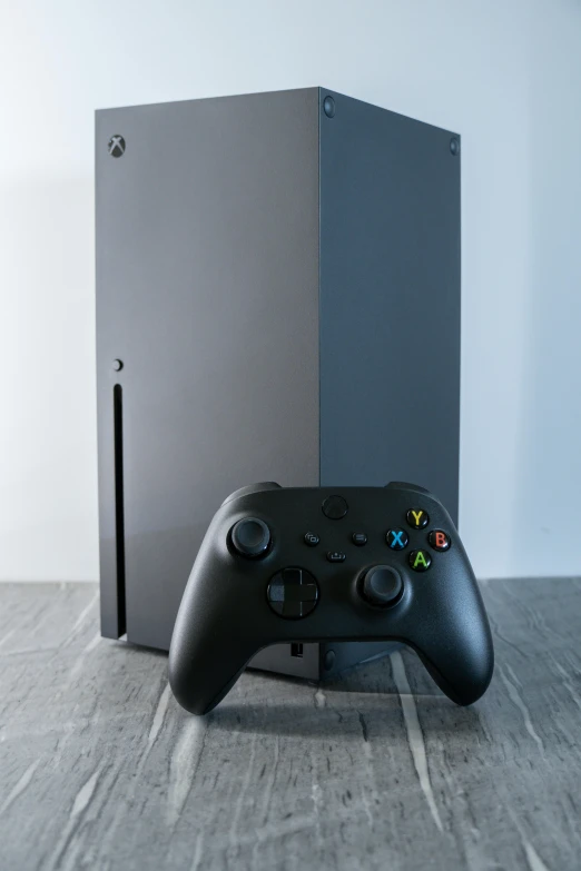 a video game controller sitting next to an external drive