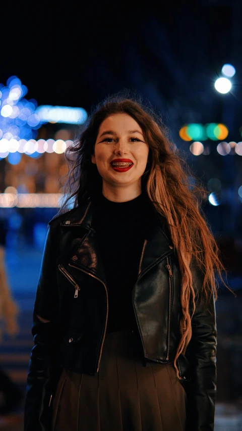 woman standing in the street at night with red lipstick