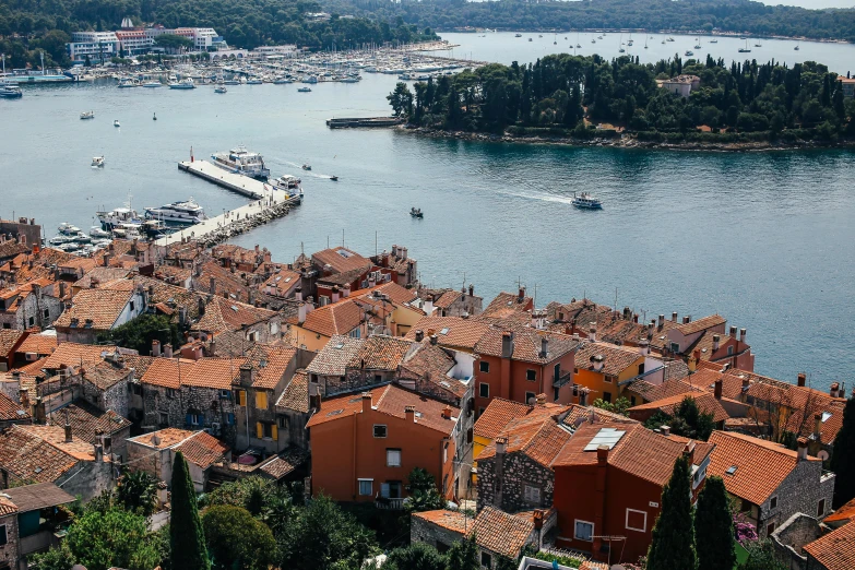 a large river with lots of red roofs and small boats