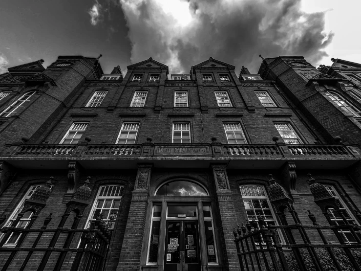 an old building is black and white with windows and bars