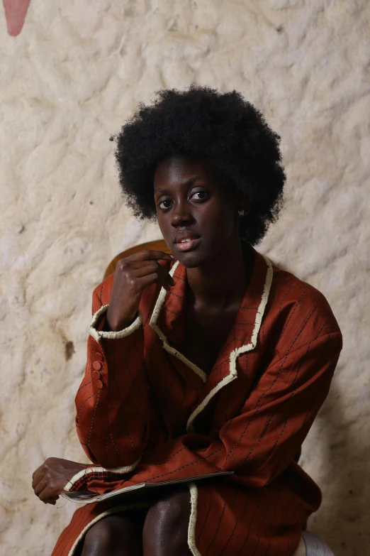 a woman is sitting down posing for the camera