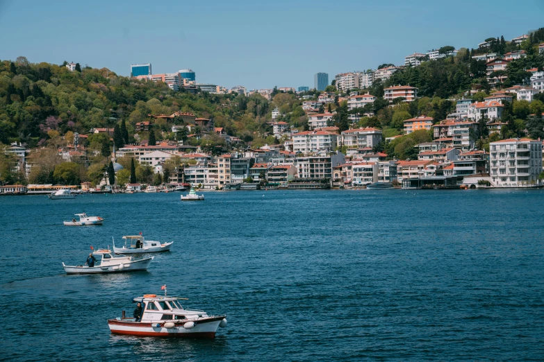 a body of water with boats in it and houses along the side