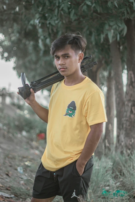 a man holding up two baseball bats standing in a field