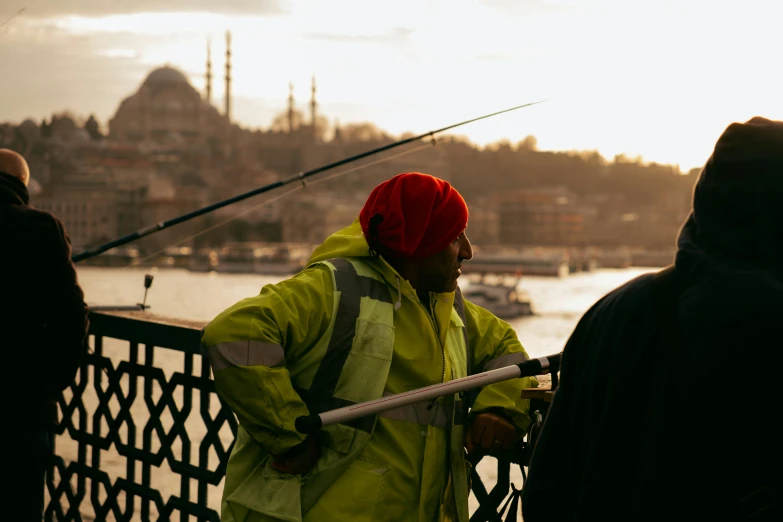 two people that are standing by some water