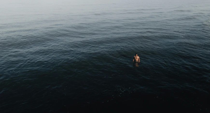 there is a person standing in the water and one looks down