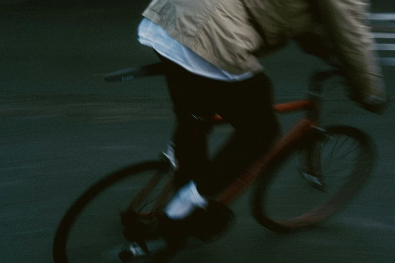 the person is riding a bicycle while talking on his cellphone