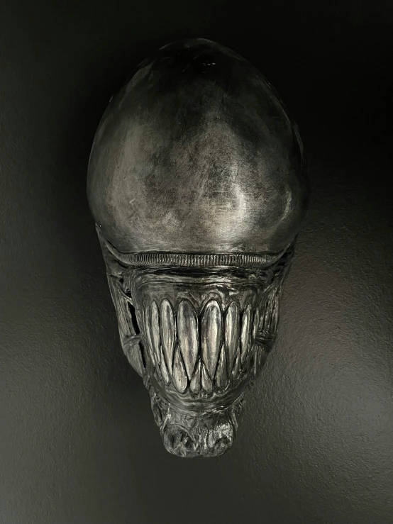 an image of a alien head hanging on a wall