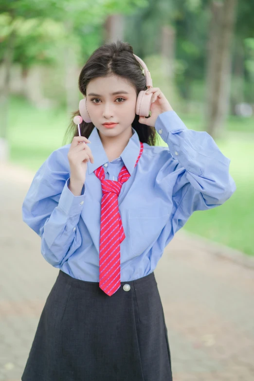 a girl with a blue shirt and a red tie