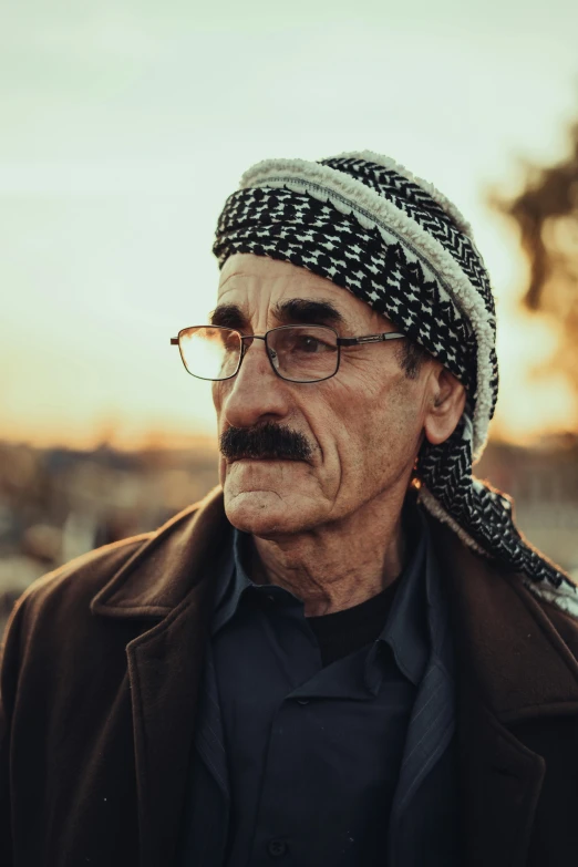 a man with glasses wearing a hat