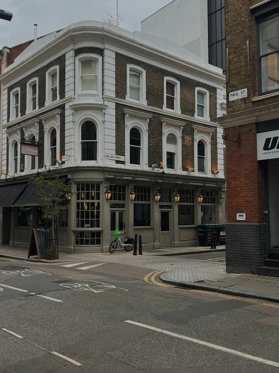 a brick and stone building with trees on the corner