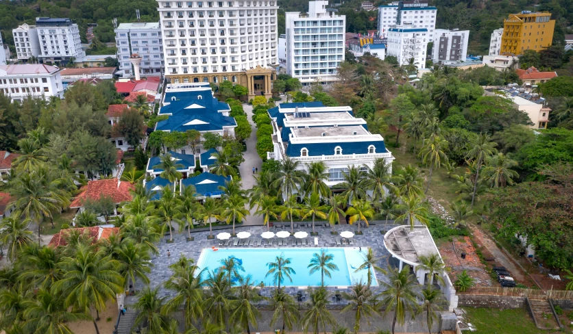 an aerial view of a pool and lots of buildings