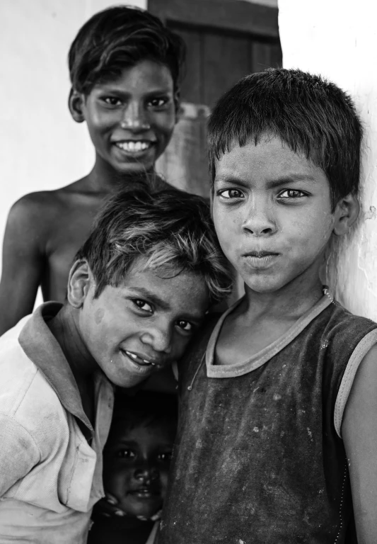 three boys in different poses posing for the camera