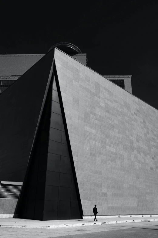 a person walking across a courtyard next to a building