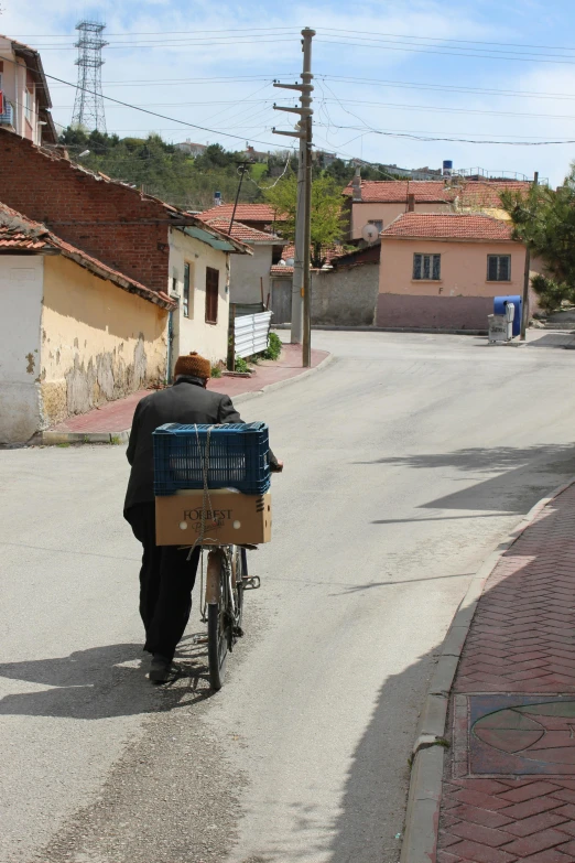 man hing a bicycle with a box on the back