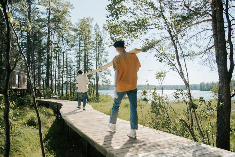 two boys playing on the boardwalk in the forest