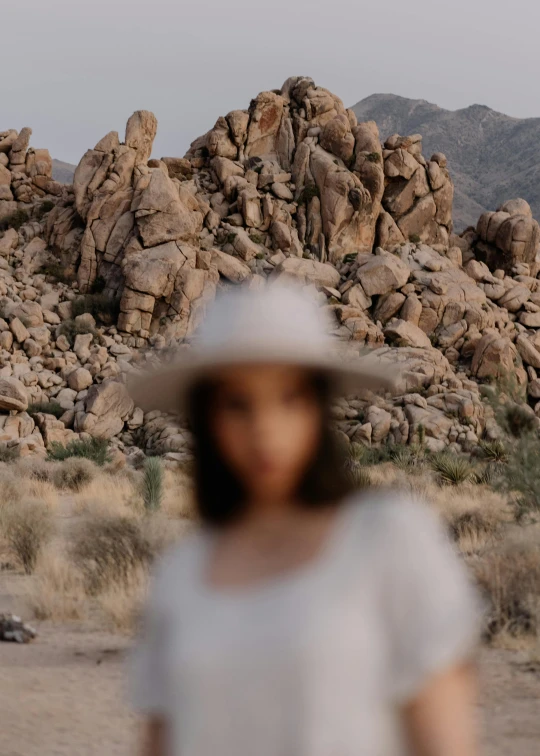 the woman is walking by the rocky terrain