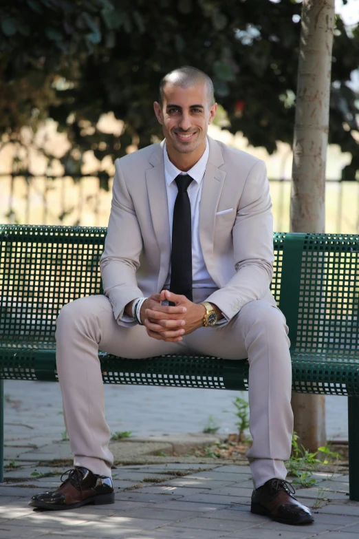 a man in a gray suit and tie, smiling for a picture