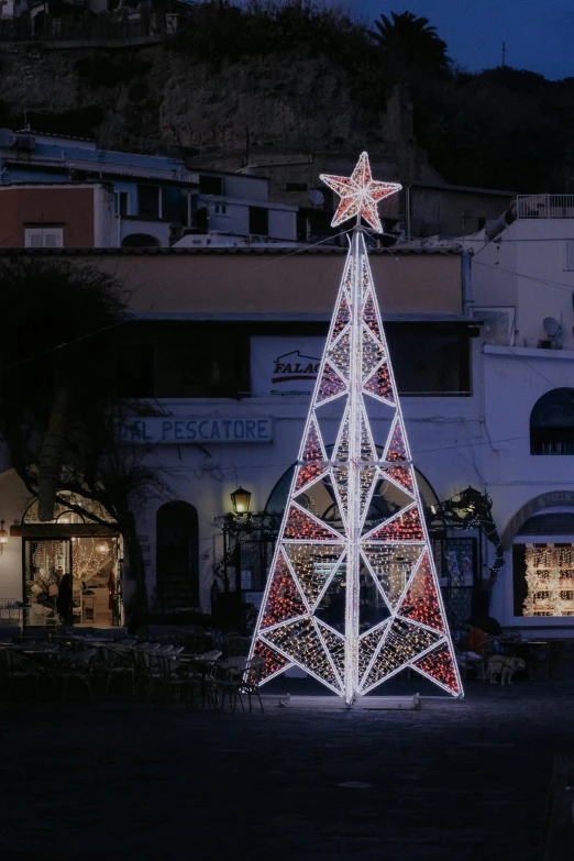 there is a christmas tree lit up on the ground