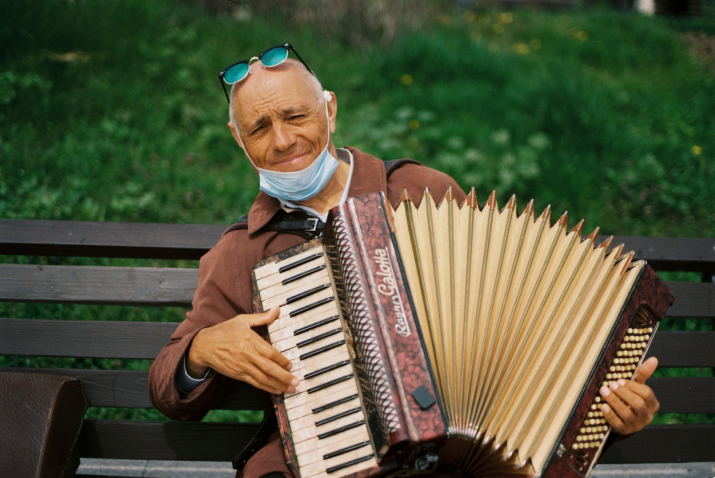 the man wearing the mask is playing a musical instrument