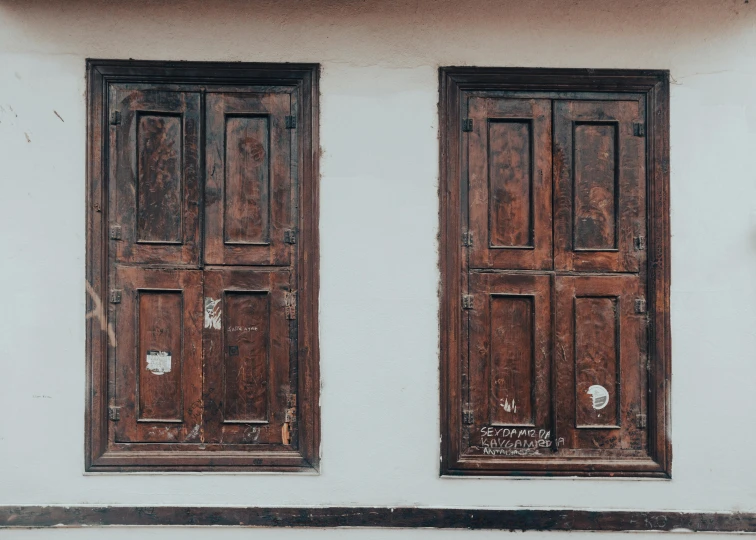 the back side of a building with two double doors